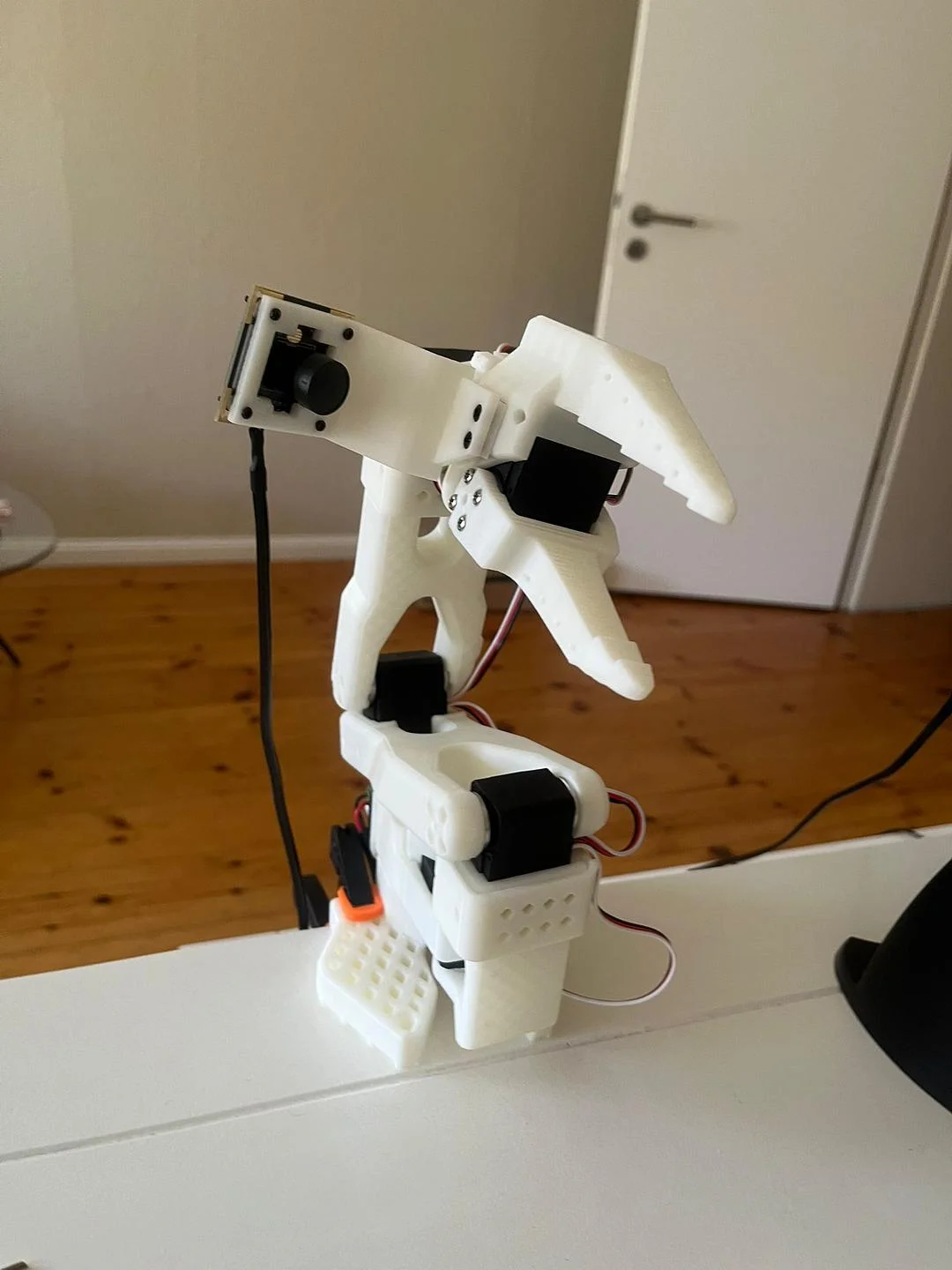 The assembled SO-101 follower arm on a desk