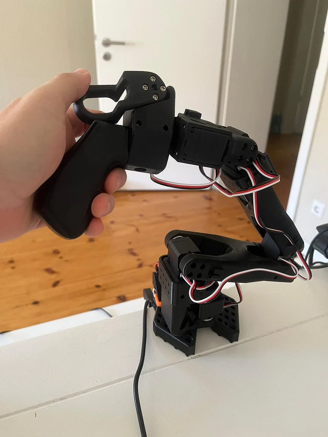 The assembled SO-101 leader arm on a desk